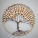 Rustic boho beaded tree of life art in a round hoop for wall hanging.